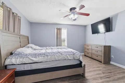 a bedroom with a bed and a flat screen tv