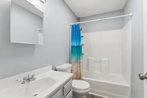 a bathroom with a sink toilet and shower