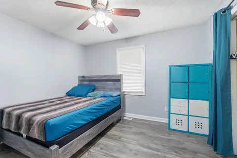 a bedroom with a bed and a chandelier