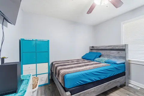 a bedroom with a bed and a window