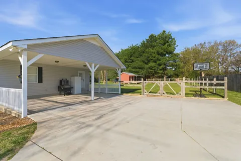 a view of a house with entertaining space and a car parked in the road