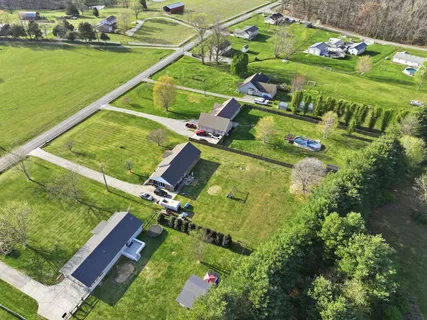an aerial view of a house with a garden and swimming pool