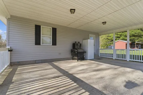 a view of a deck with wooden floor and a yard
