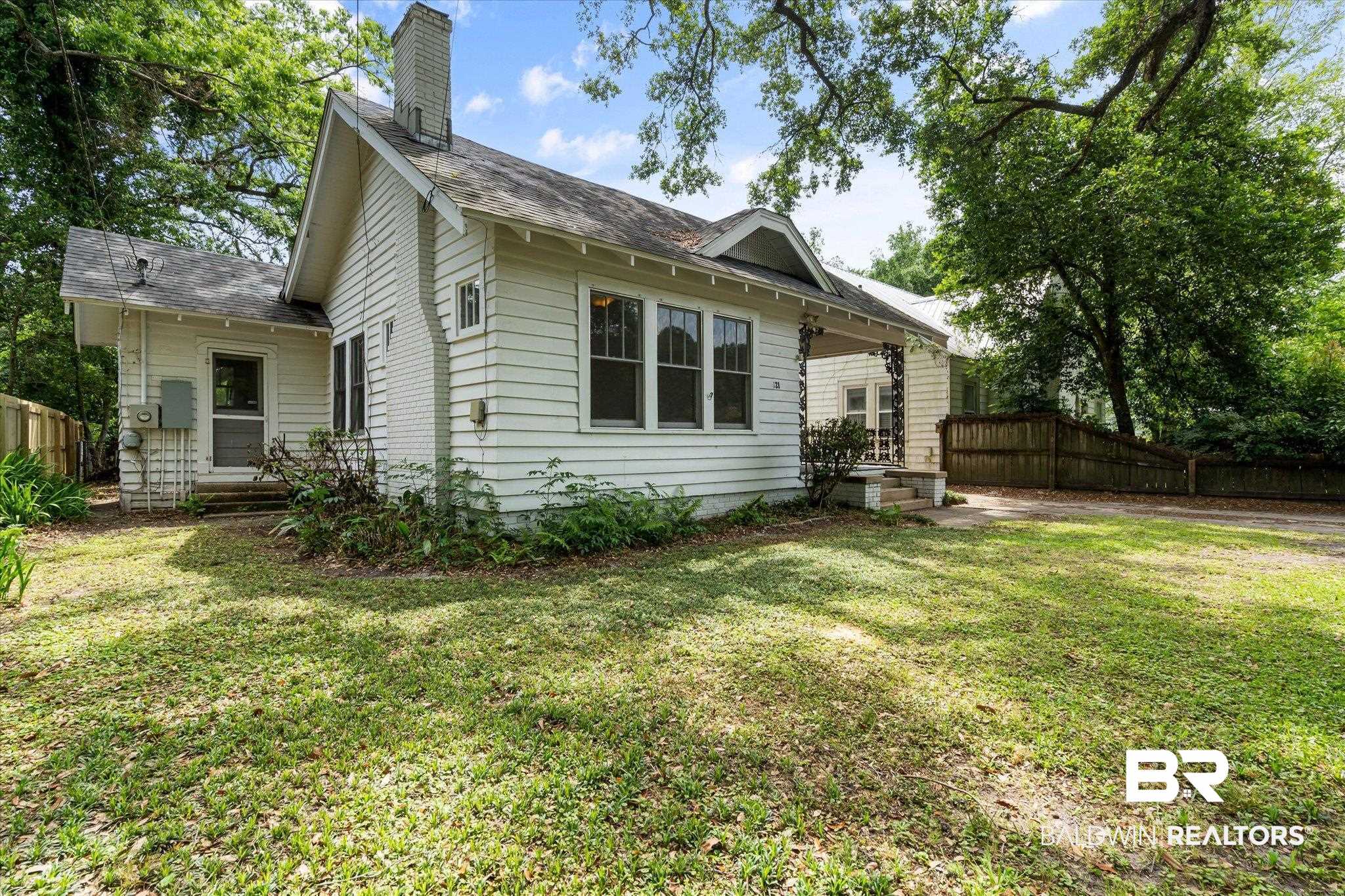 121 Westwood Street Mobile, AL 36606 - Photo 20 of 20 Exterior space with a lawn, a shingled roof, a chimney, and fence
