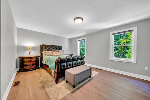 a bedroom with a bed couch and a window