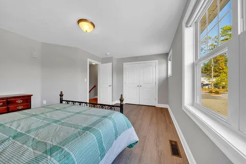 a bedroom with a bed and a window