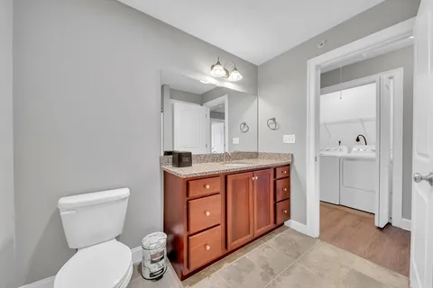 a bathroom with a toilet sink and mirror