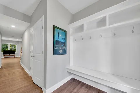 a view of hallway with wooden floor