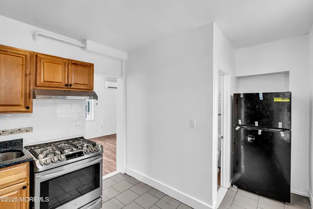 a kitchen with a stove and a refrigerator
