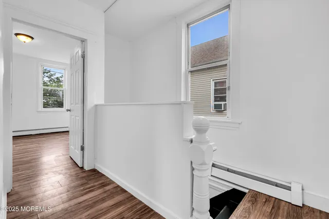 a view of an entryway with wooden floor and door