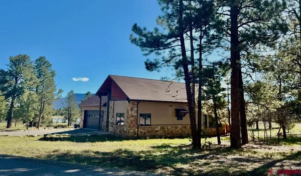 a view of house with yard