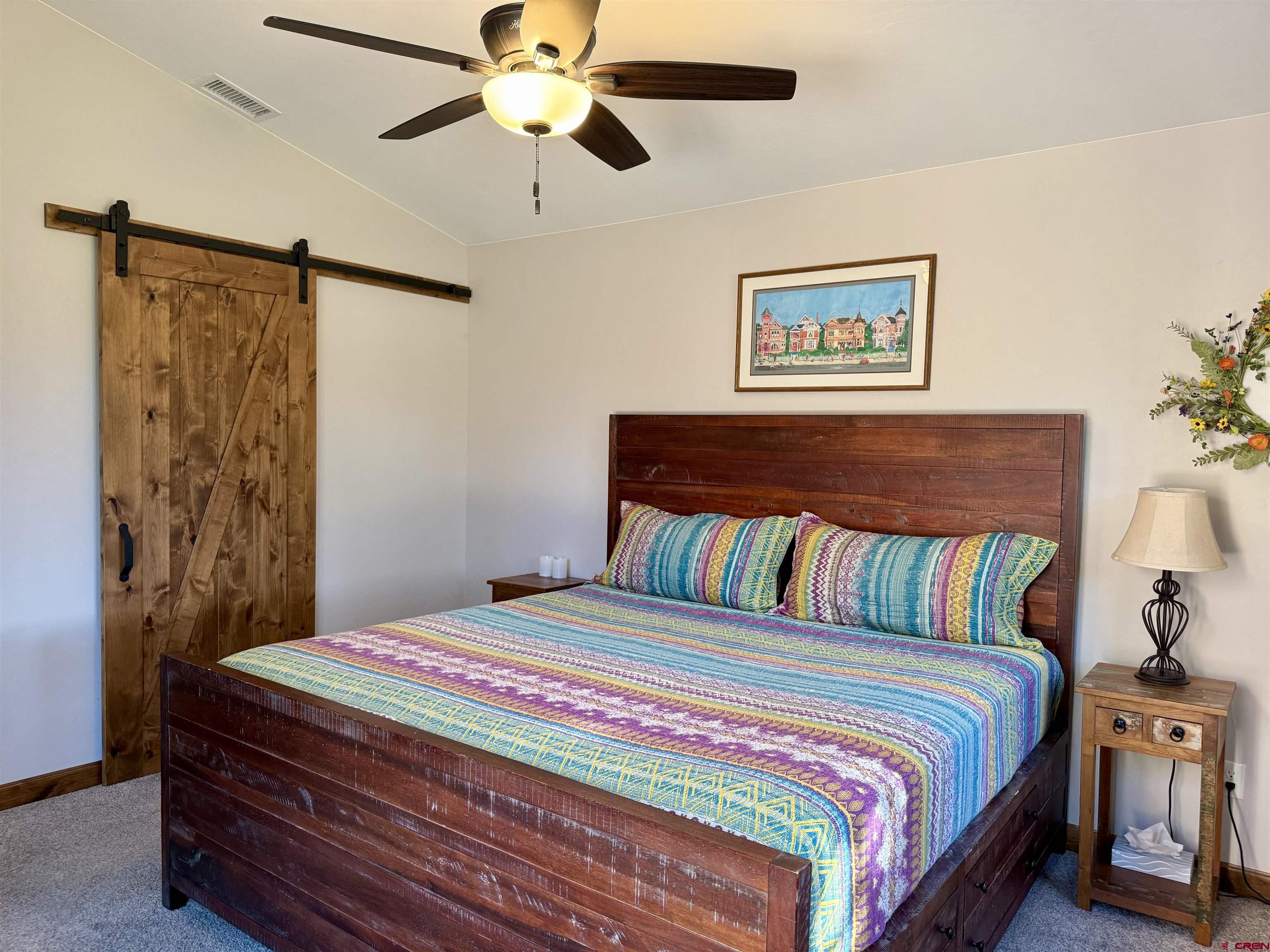 592 South Badger Trail Ridgway, CO 81432 - Photo 11 of 29 a bedroom with a bed and a chandelier