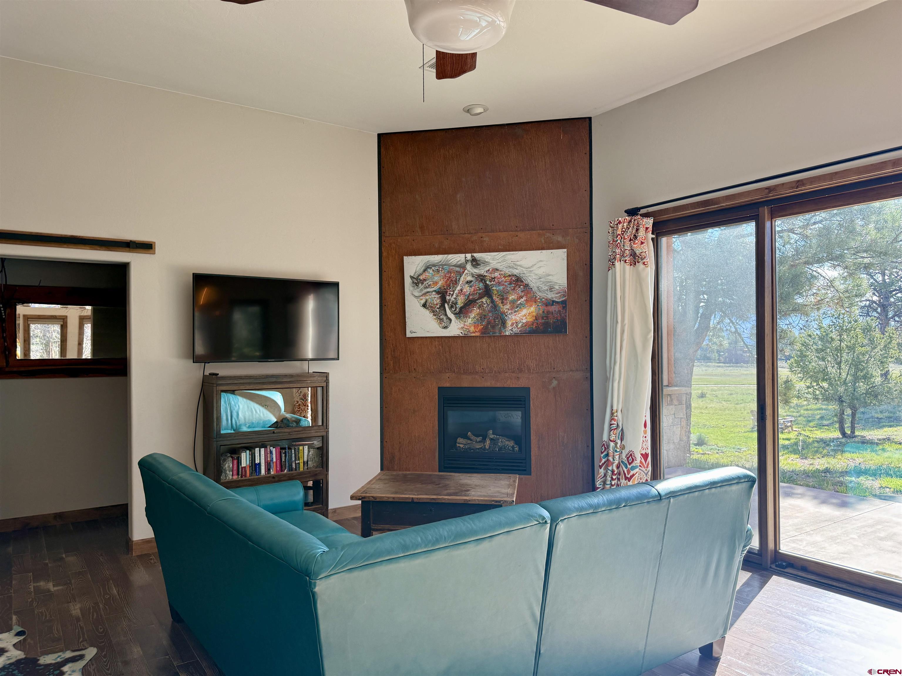 592 South Badger Trail Ridgway, CO 81432 - Photo 12 of 29 a living room with furniture a flat screen tv and a fireplace