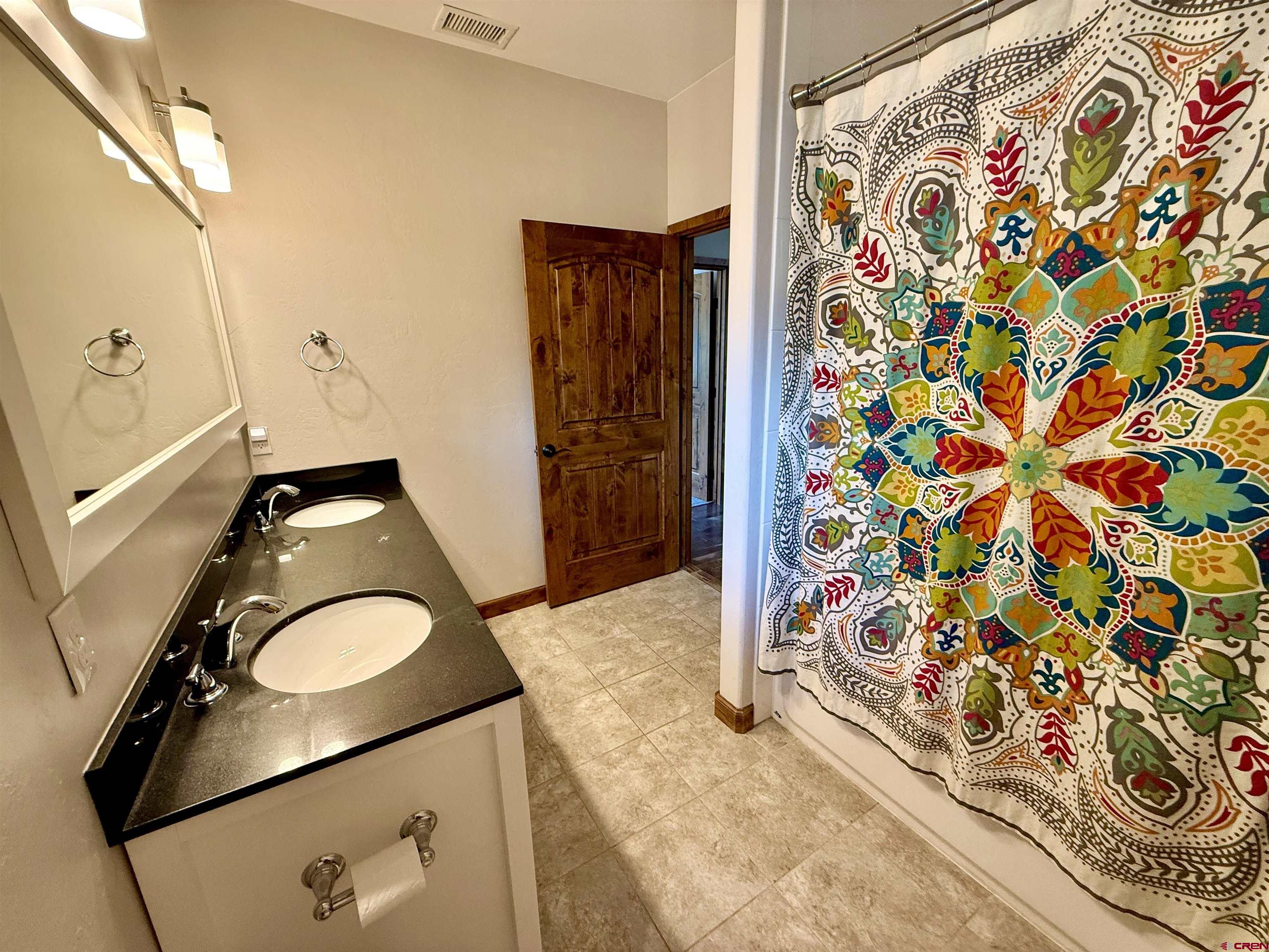 592 South Badger Trail Ridgway, CO 81432 - Photo 13 of 29 a bathroom with a granite countertop sink and a mirror