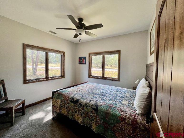 592 South Badger Trail Ridgway, CO 81432 - Photo 16 of 29 a bedroom with a bed and a window