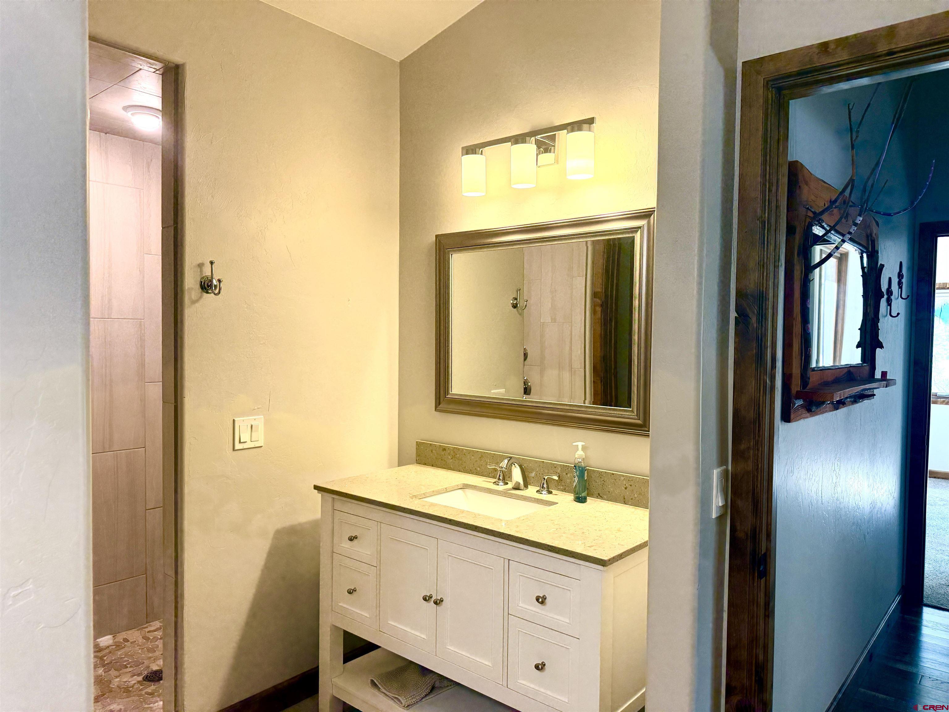 592 South Badger Trail Ridgway, CO 81432 - Photo 17 of 29 a bathroom with a granite countertop sink and a mirror