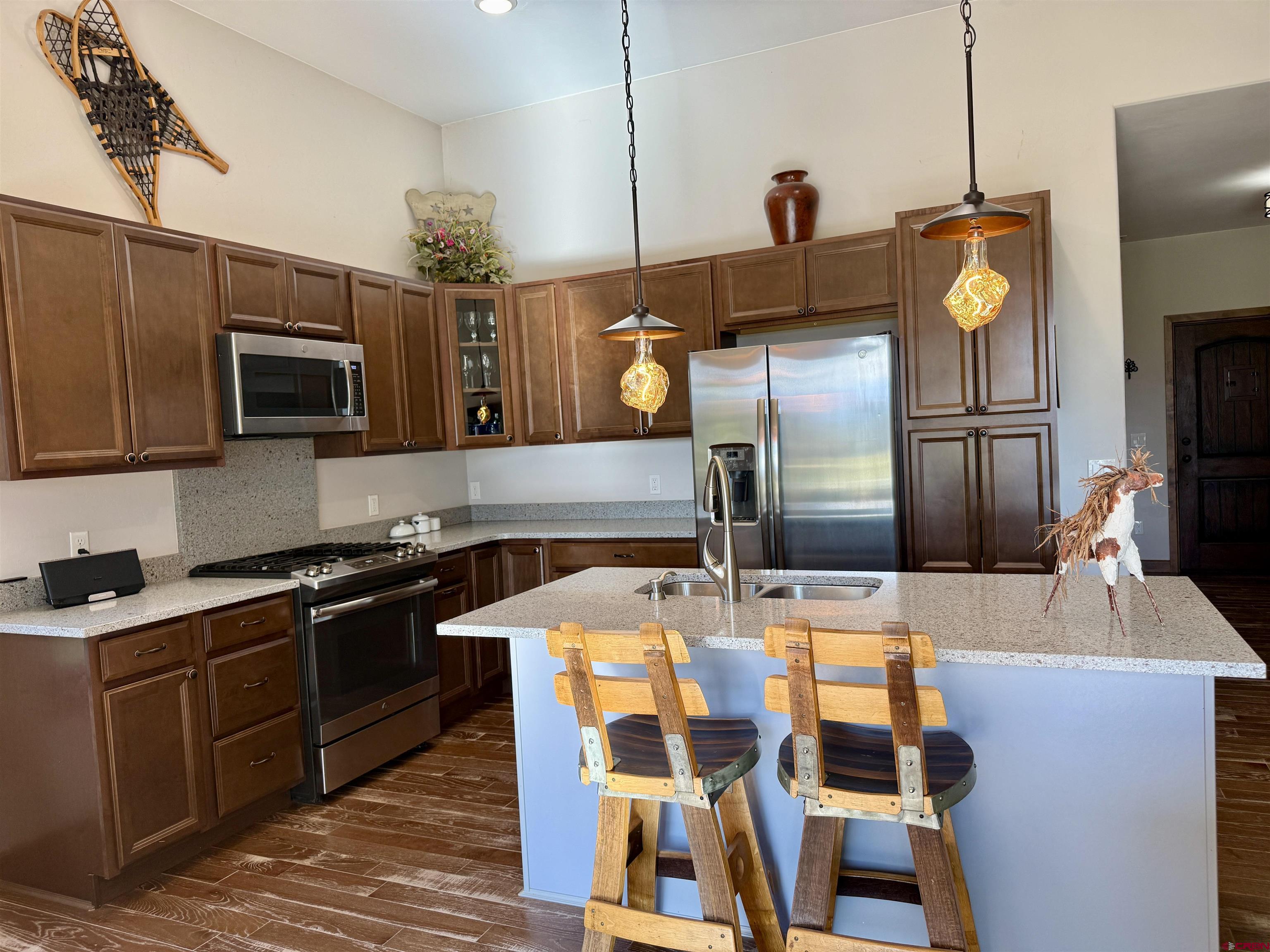 592 South Badger Trail Ridgway, CO 81432 - Photo 5 of 29 a kitchen with stainless steel appliances wooden floor dining table and chairs