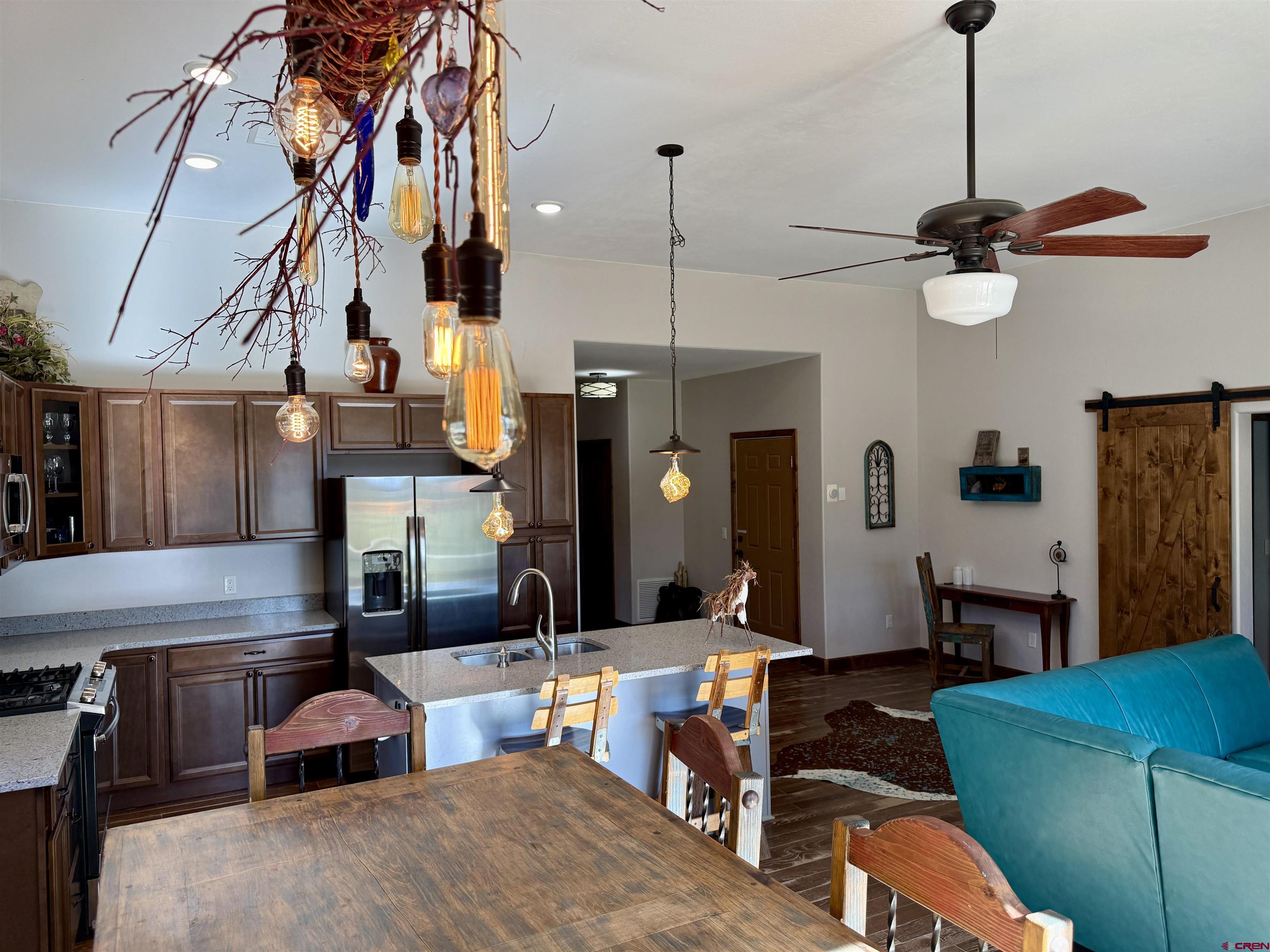 592 South Badger Trail Ridgway, CO 81432 - Photo 7 of 29 a living room with furniture gym equipment and a chandelier