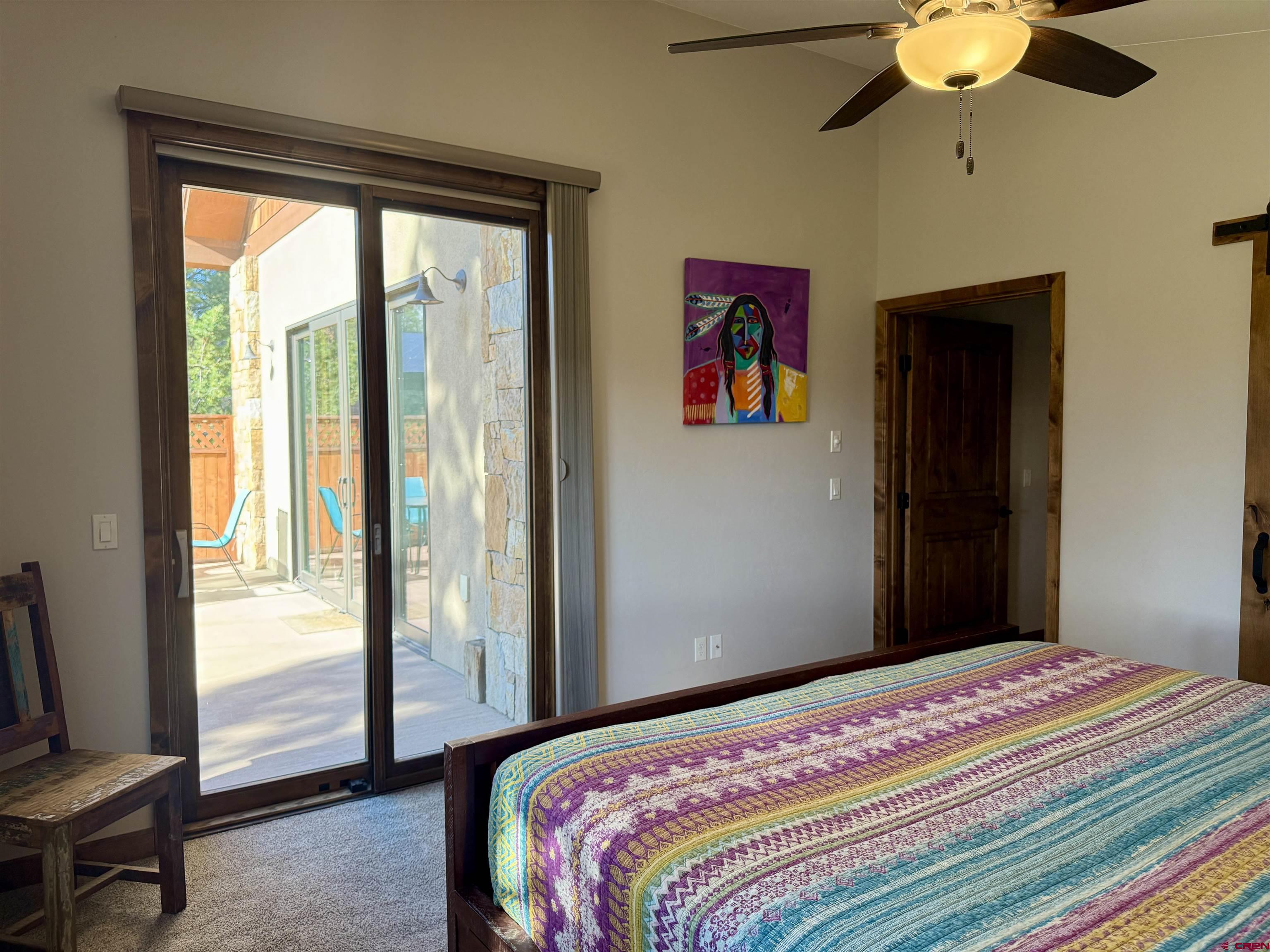 592 South Badger Trail Ridgway, CO 81432 - Photo 9 of 29 a bedroom with a bed and a chandelier