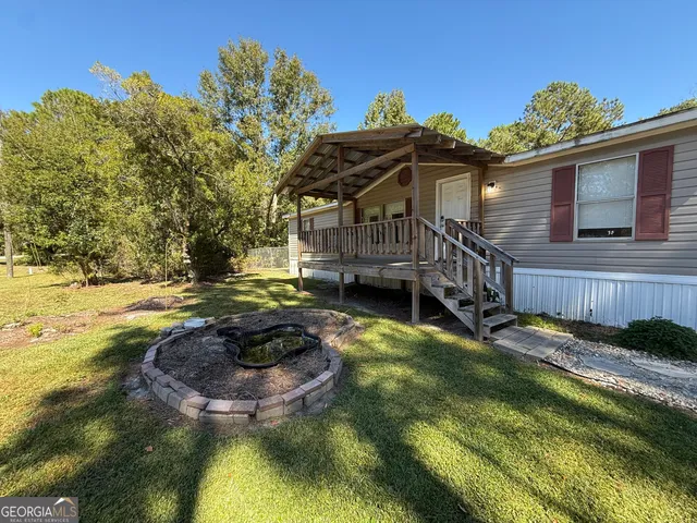 a view of a house with a swimming pool and a yard