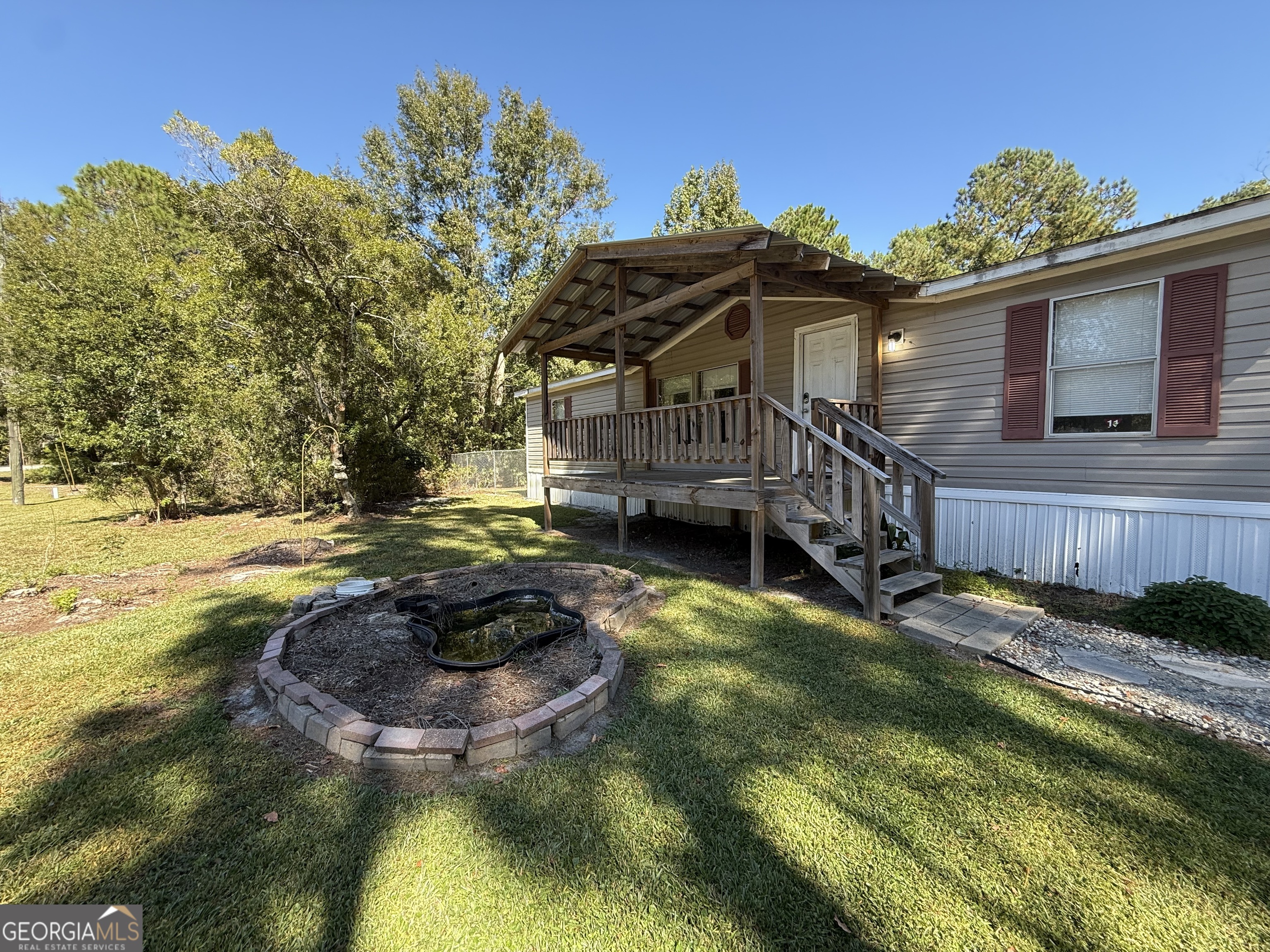 a view of a house with a swimming pool and a yard