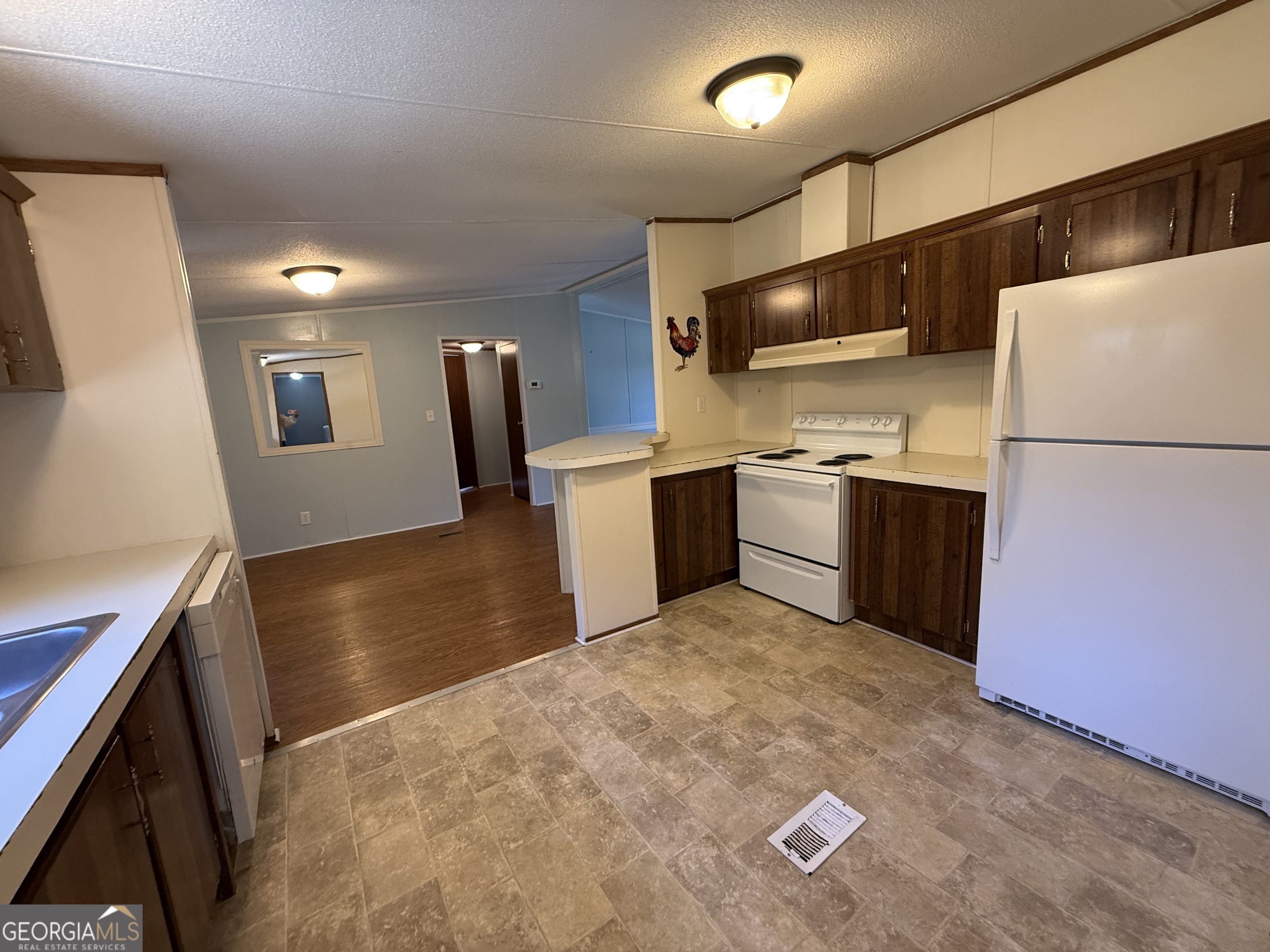 802 Ash Branch Road Pembroke, GA 31321 - Photo 11 of 27 a kitchen with stainless steel appliances granite countertop a sink a stove and a refrigerator
