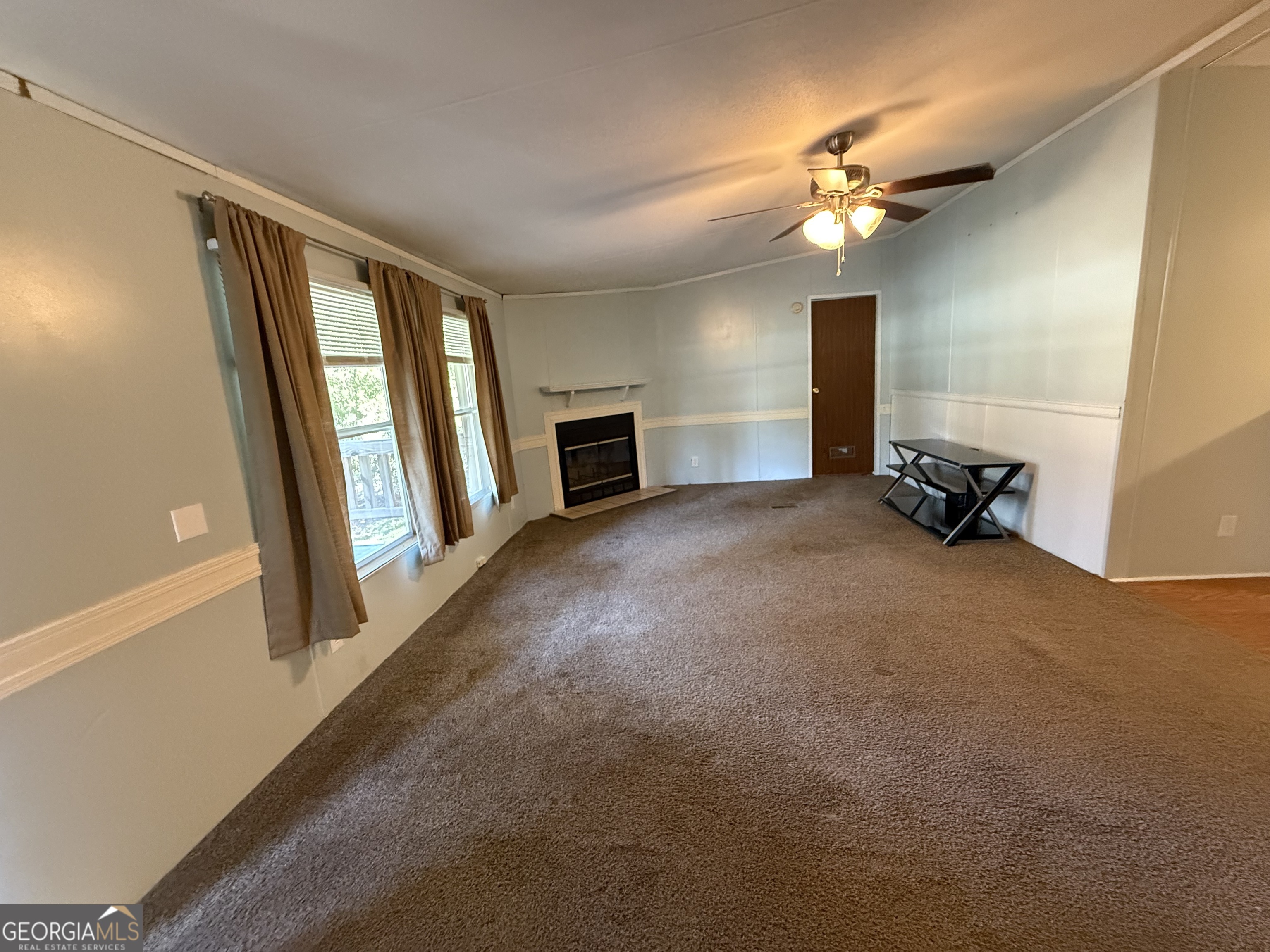 802 Ash Branch Road Pembroke, GA 31321 - Photo 17 of 27 a view of a room with a hanging light and hardwood floor