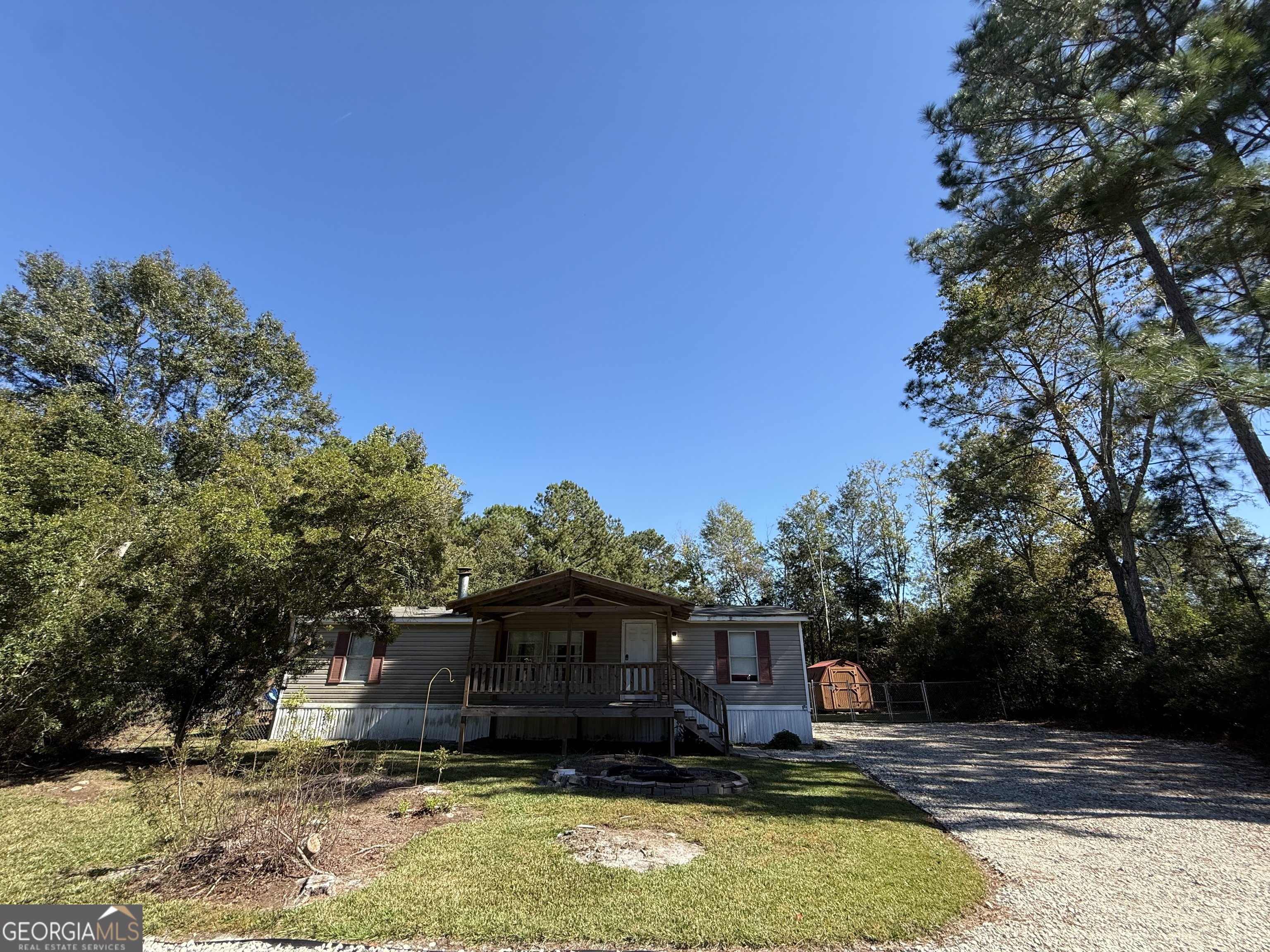 802 Ash Branch Road Pembroke, GA 31321 - Photo 3 of 27 a view of a house with swimming pool next to a yard