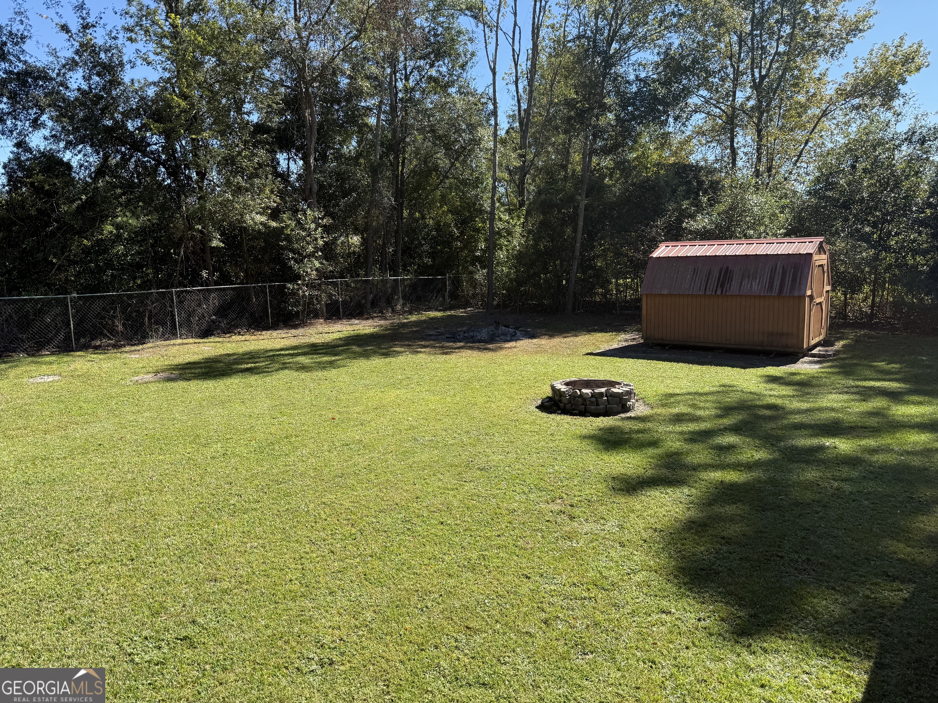 802 Ash Branch Road Pembroke, GA 31321 - Photo 4 of 27 a backyard of a house with lots of green space