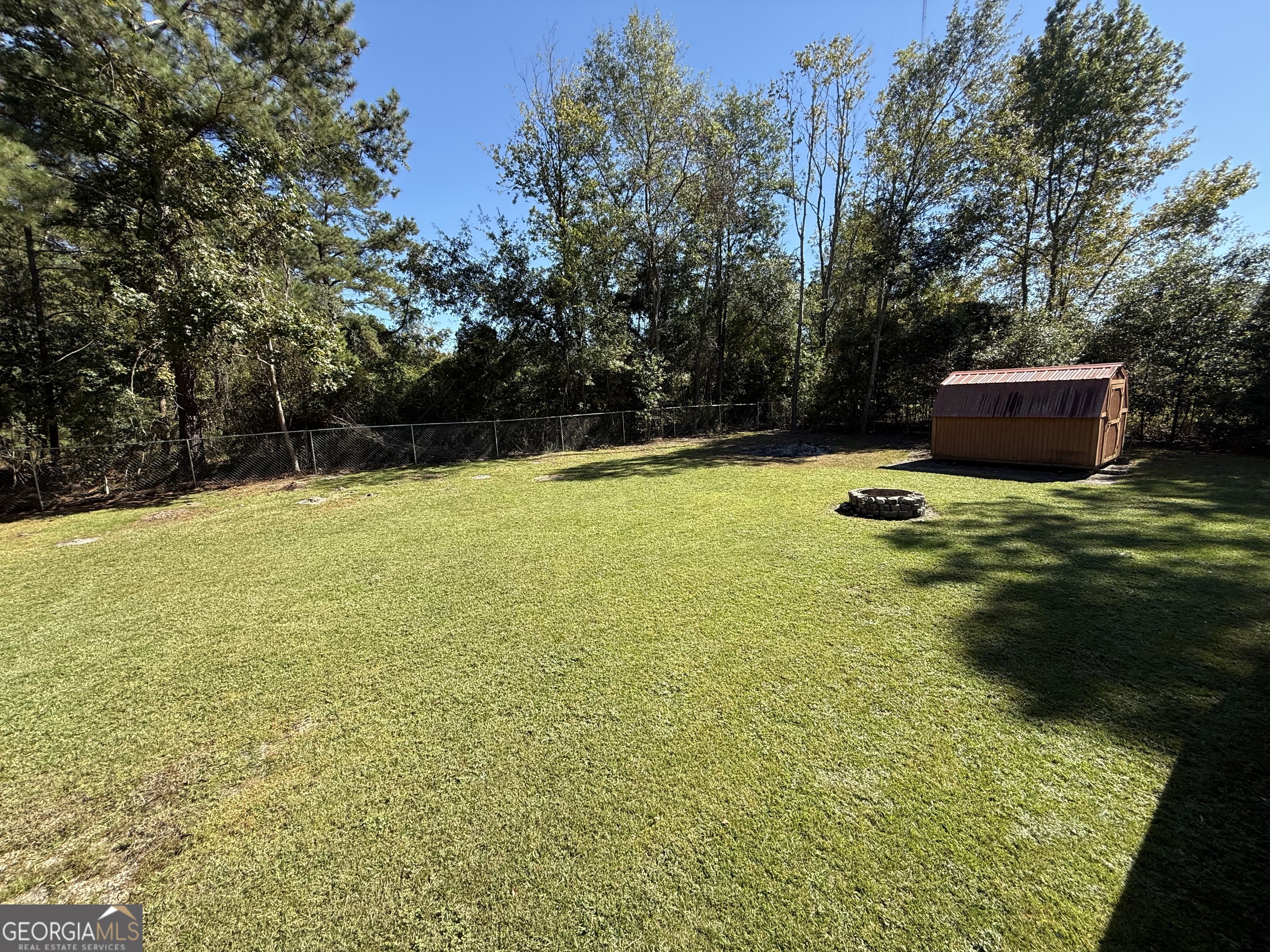 802 Ash Branch Road Pembroke, GA 31321 - Photo 6 of 27 a swimming pool with wooden fence