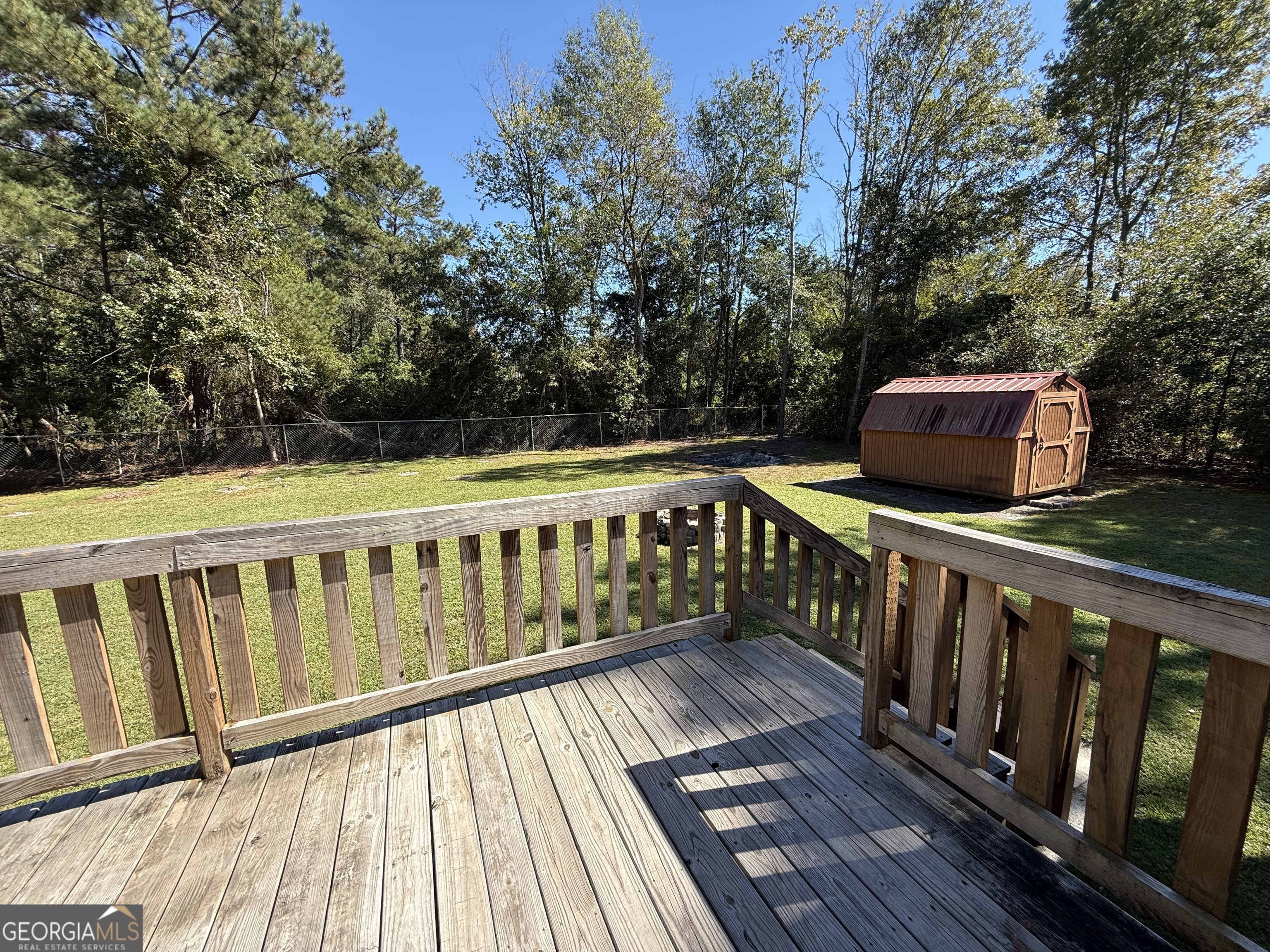 802 Ash Branch Road Pembroke, GA 31321 - Photo 8 of 27 a view of deck with wooden floor and fence