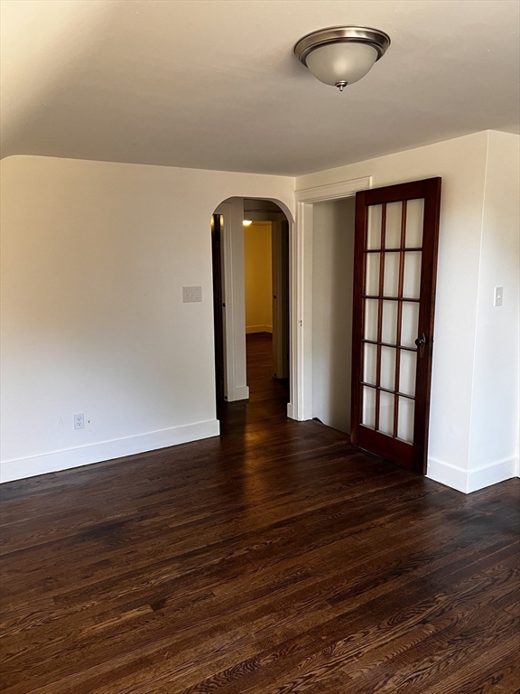 30 A Beechmont Street, Unit 2 Worcester, MA 01609 - Photo 2 of 8 a view of an empty room with wooden floor and a window
