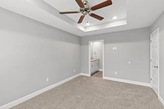 an empty room and chandelier fan