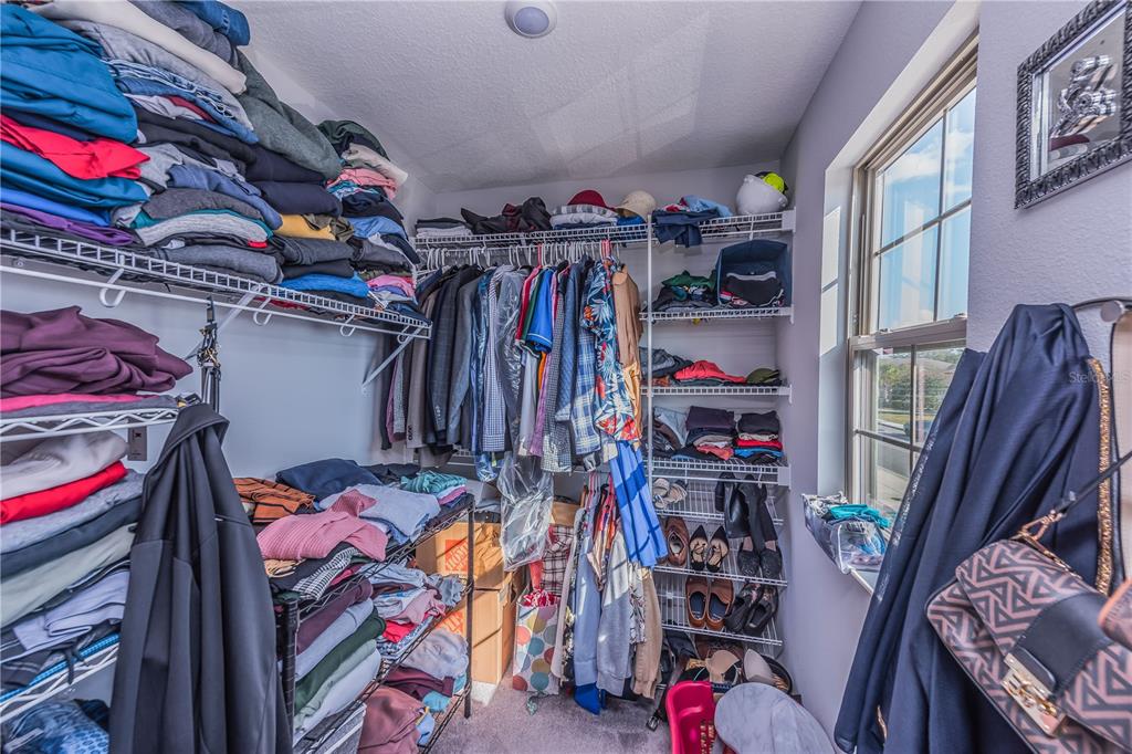 220 Evertree Loop Sanford, FL 32771 - Photo 14 of 31 a view of walk in closet with clothes and shoes