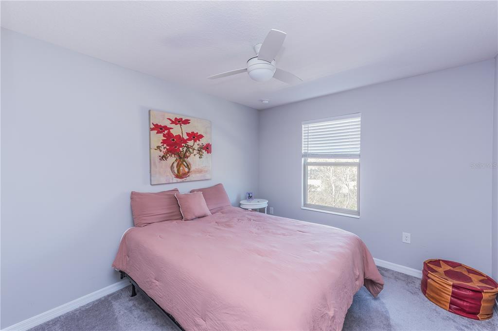 220 Evertree Loop Sanford, FL 32771 - Photo 16 of 31 a bedroom with a bed and a chandelier