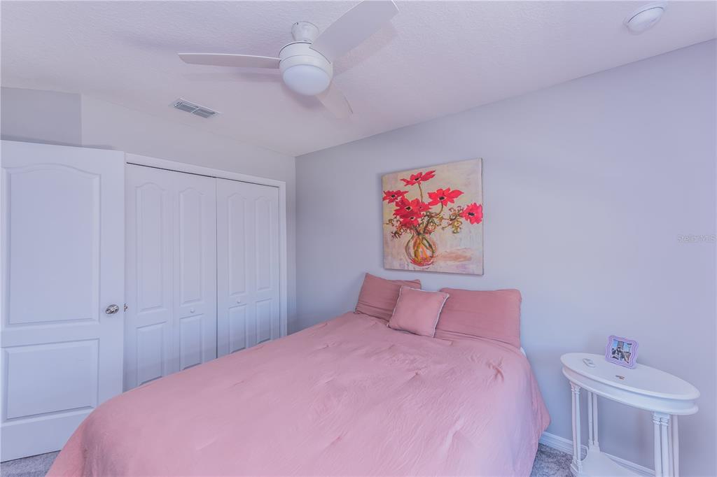 220 Evertree Loop Sanford, FL 32771 - Photo 17 of 31 a bedroom with a bed and a painting on the wall