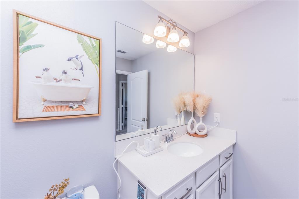 220 Evertree Loop Sanford, FL 32771 - Photo 20 of 31 a bathroom with a sink vanity and a mirror