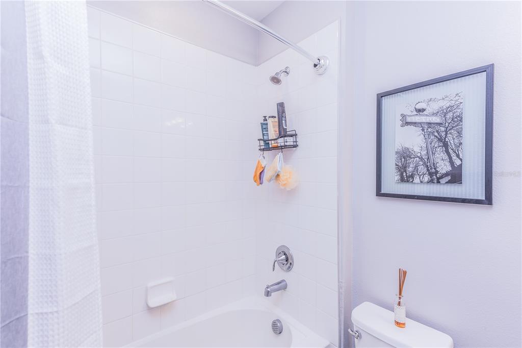 220 Evertree Loop Sanford, FL 32771 - Photo 25 of 31 a bathroom with a bathtub and a shower