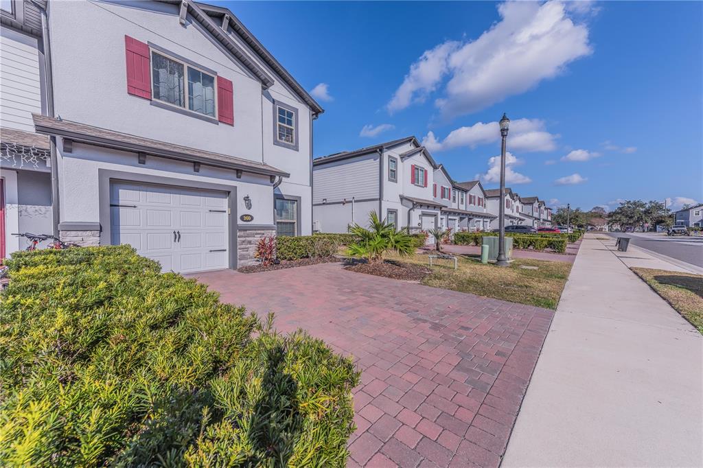 220 Evertree Loop Sanford, FL 32771 - Photo 3 of 31 a front view of a house with a yard and a garage