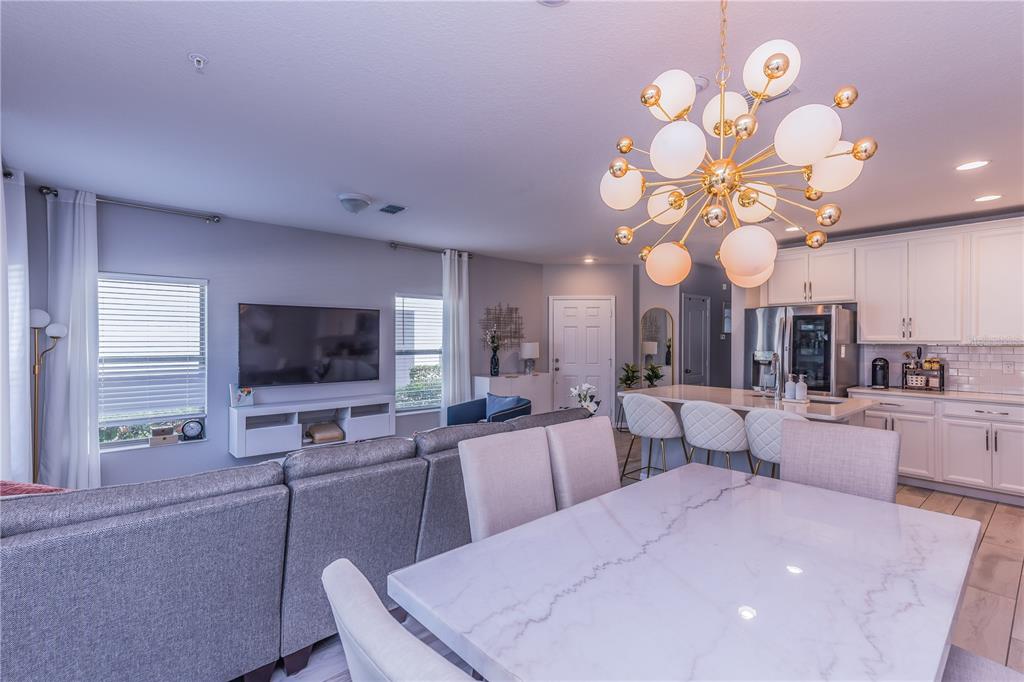 220 Evertree Loop Sanford, FL 32771 - Photo 8 of 31 a large room with lots of table and chairs