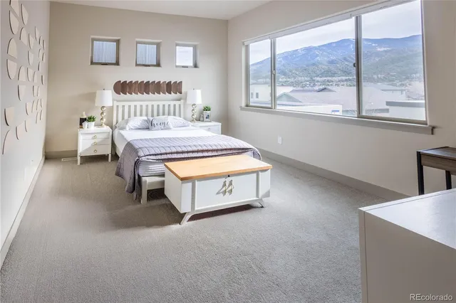 a bedroom with a bed and a night stand