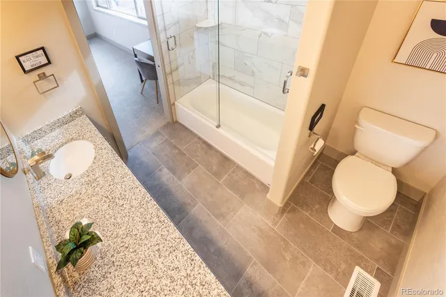 a bathroom with a toilet and a tub