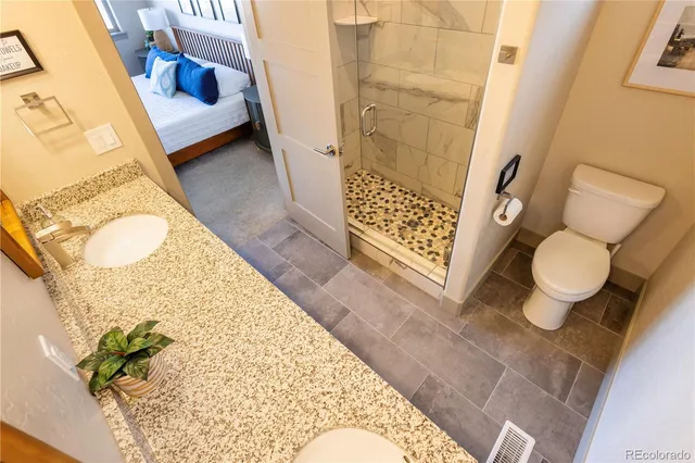 a bathroom with a sink toilet and shower