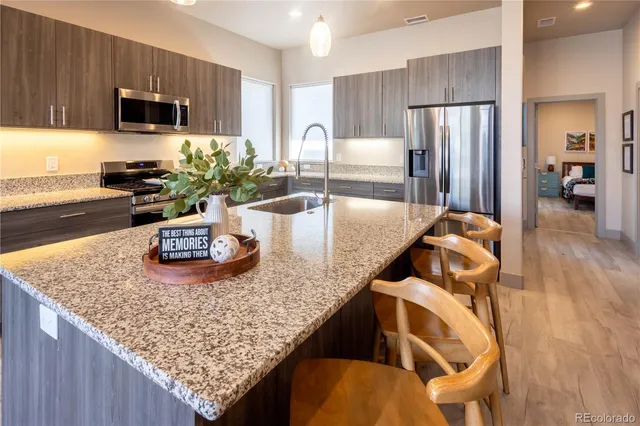 a kitchen with furniture and a refrigerator