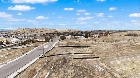 a view of a chairs and table in the back yard