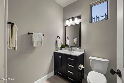 a bathroom with a toilet a sink and mirror