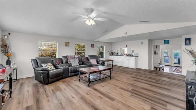 a living room with furniture and a wooden floor
