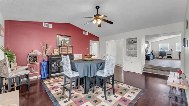 a view of a a dining room with furniture window and wooden floor