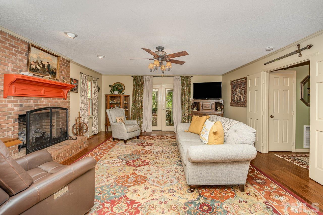 2025 Valley Ridge Court Raleigh, NC 27603 - Photo 14 of 32 a living room with furniture a fireplace and a flat screen tv