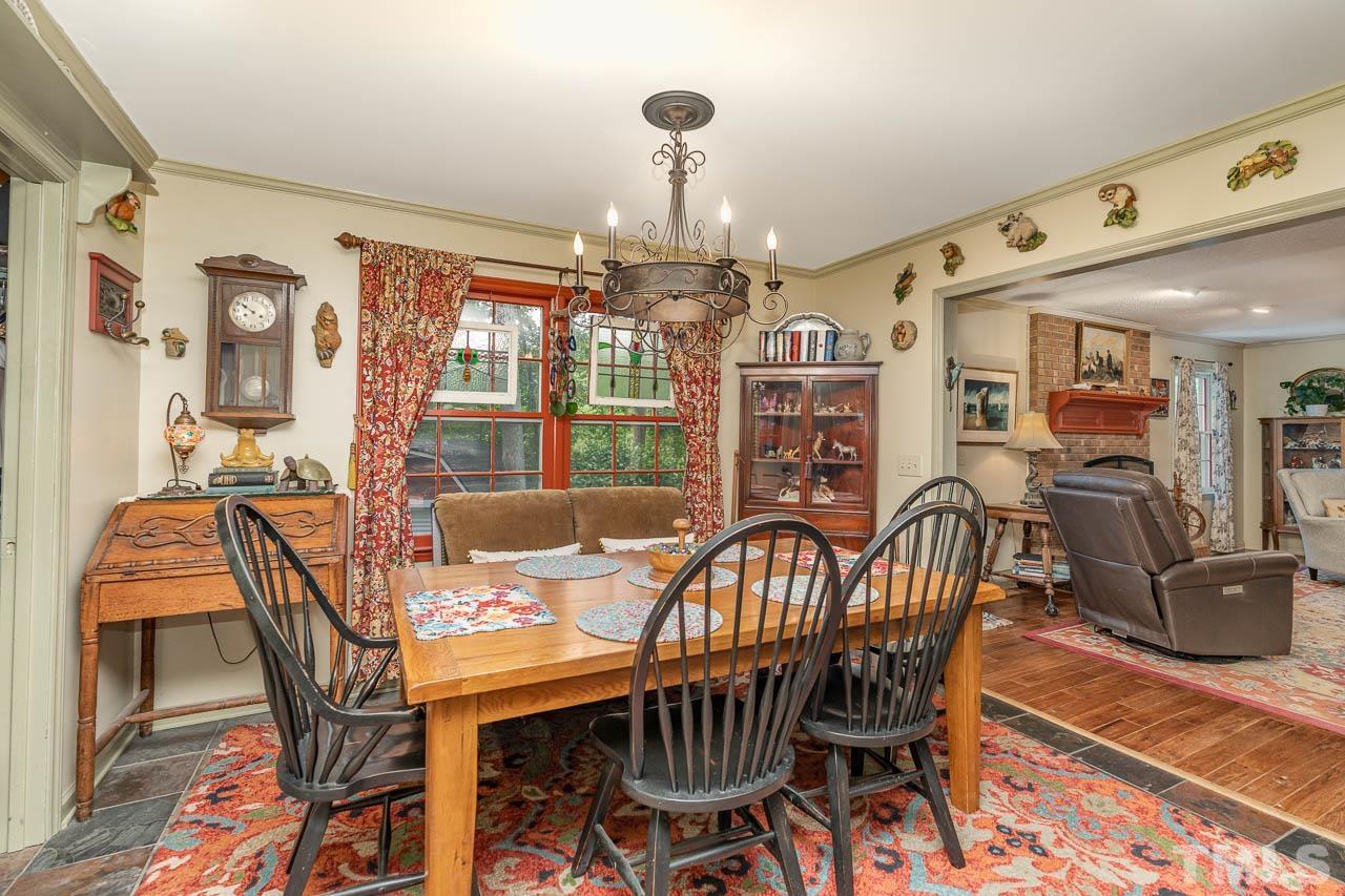 2025 Valley Ridge Court Raleigh, NC 27603 - Photo 19 of 32 a view of a dining room with furniture window and wooden floor